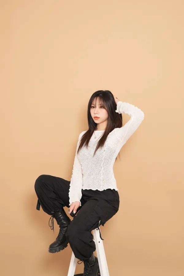 A woman sitting on a stool
